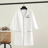 Custom white short sleeve lab coat for spa and beauty professionals with pockets, women's beauty uniform.