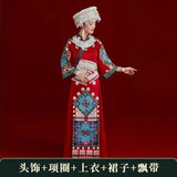 Miao embroidery suit worn by a woman, featuring vibrant colors and intricate patterns, perfect for festival celebrations.