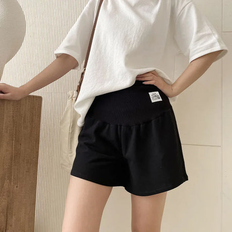 Plus size adjustable maternity shorts in black, featuring a loose fit, ideal for summer wear for expectant mothers.