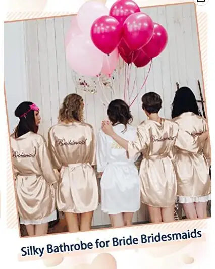 Group of bridesmaids in silky bathrobes celebrating with pink balloons, showcasing stylish and elegant bridal party wear.