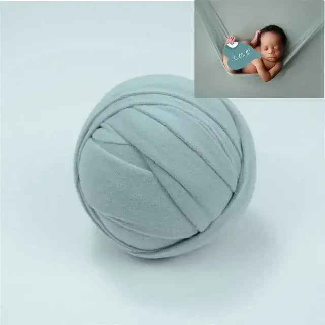 Soft grey blanket ball backdrop for newborn photo shoots, featuring a cozy design ideal for baby photography.