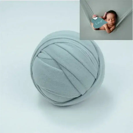 Soft grey blanket ball backdrop for newborn photo shoots, featuring a cozy design ideal for baby photography.