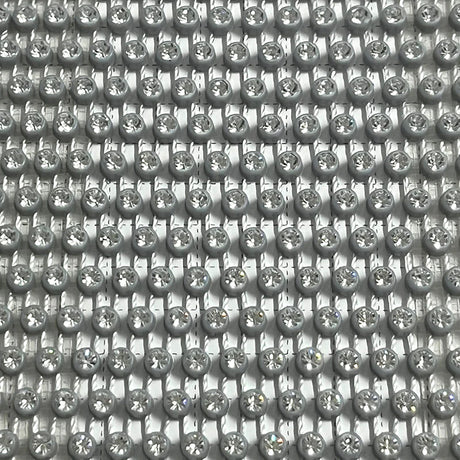 Close-up of shimmering rhinestones in a pattern, ideal for glamorous clothing and accessories.