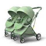 Green twin baby stroller with adjustable canopies and comfortable seating for two infants, perfect for ages 0-6 years.