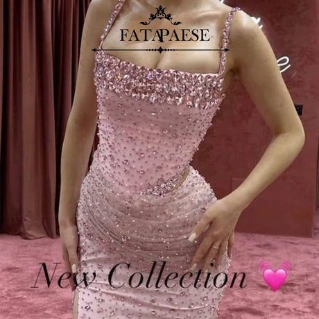 Sexy pink mermaid wedding dress with crystal beads and thin straps from FATAPAESE, showcasing elegance and luxury.