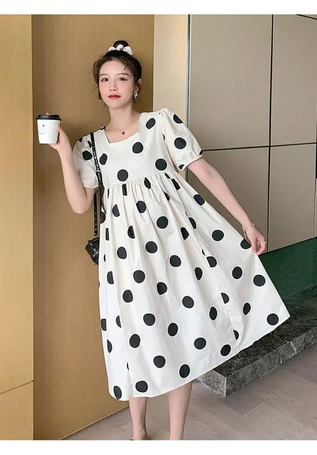 Polka dot loose maternity dress in black and white, perfect for summer. Casual style and mid-calf length, ideal for all seasons.
