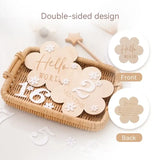 Wooden baby flower-shaped milestone cards, double-sided design for tracking age, in a woven basket.