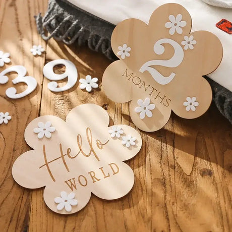 Wooden flower-shaped milestone cards for babies, 2 months and 'Hello World' design, perfect for maternity photo ops.
