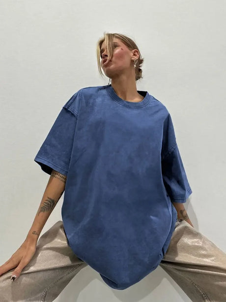 Model wearing a blue oversized casual t-shirt, showcasing its relaxed fit and stylish design.