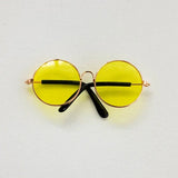Colorful round glasses for newborn photography, featuring yellow lenses and stylish black arms. Perfect baby accessories.