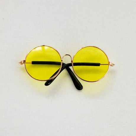 Colorful round glasses for newborn photography, featuring yellow lenses and stylish black arms. Perfect baby accessories.