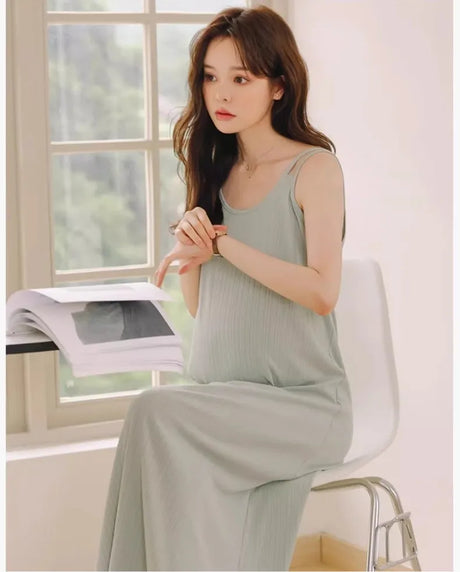 Sleeveless strap maternity dress in natural color, perfect for summer outdoor wear, showcasing a relaxed casual style.