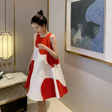 Loose sleeveless Korean maternity dress in red and white, perfect for summer, showcased in a stylish indoor setting.