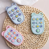Colorful silicone toy phones for kids in blue, green, and pink, designed for playful learning and sensory engagement.