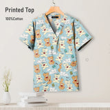 Colorful bear-printed cotton scrub top for pediatric nursing, featuring breathable fabric and V-neck design.
