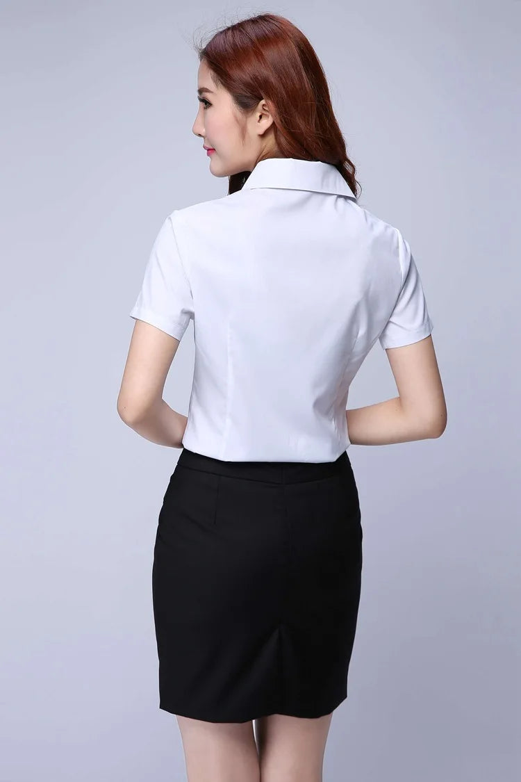 Back view of a woman wearing a white short sleeve shirt with a black skirt, ideal for youthful office style.