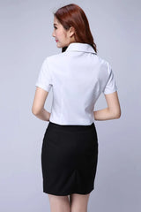 Back view of a woman wearing a white short sleeve shirt with a black skirt, ideal for youthful office style.