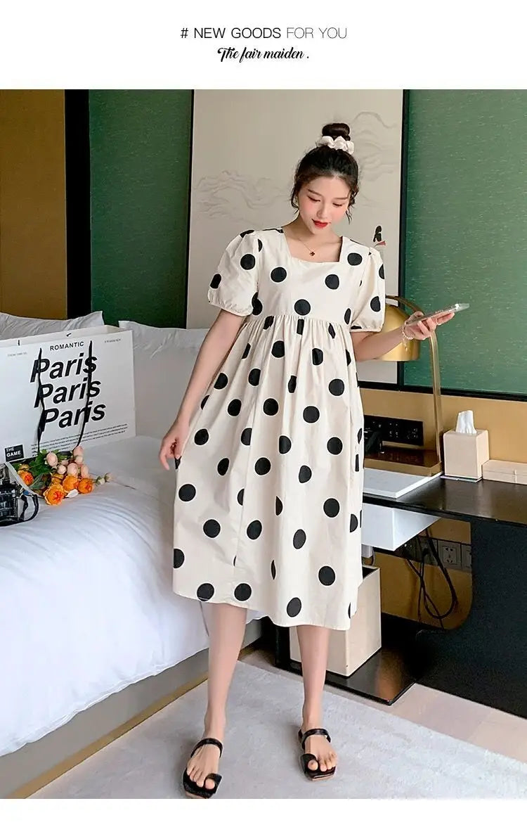 Polka dot loose maternity dress showcasing a comfortable mid-calf style, perfect for summer wear.
