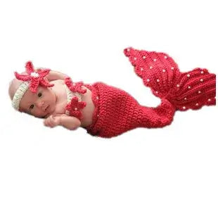 Baby in a red crochet mermaid costume with a flower headband, perfect for 0-6 months, unisex baby outfit.