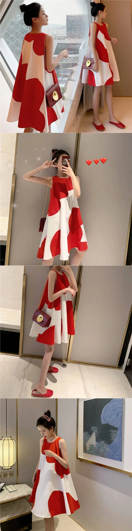 Woman in a loose sleeveless red and white polka dot summer dress, posing in a modern indoor setting.