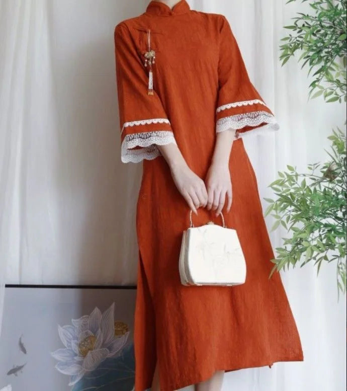 Cotton Jacquard Cheongsam Qipao Dress in orange with lace details and a stylish handbag.