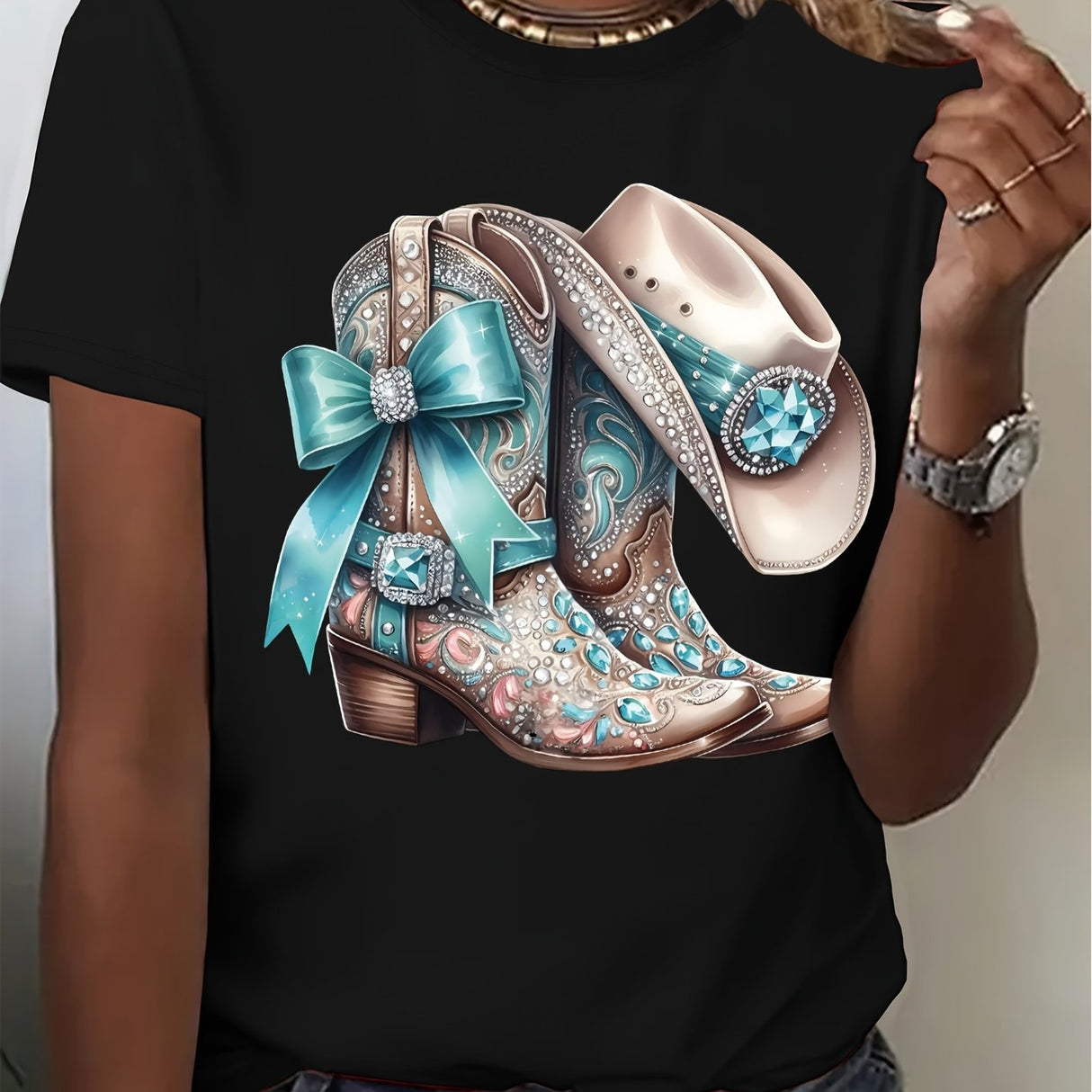 Stylish black t-shirt featuring a colorful design of cowboy boots with bows and embellishments.